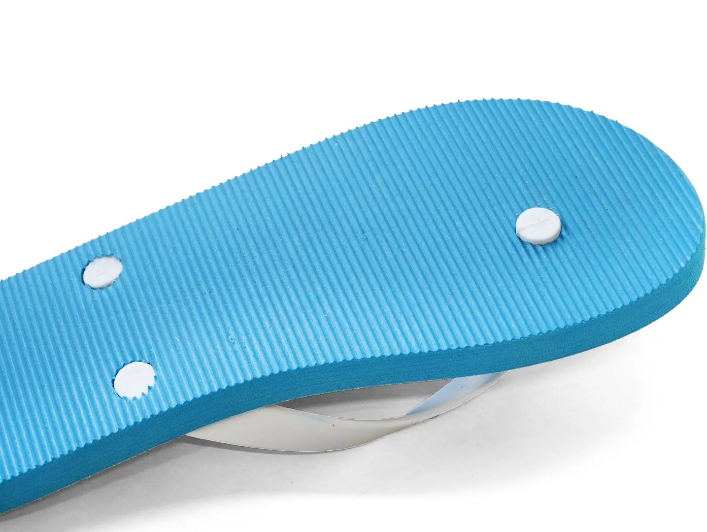 青いビーチサンダルの底のクローズアップ写真。白い背景に